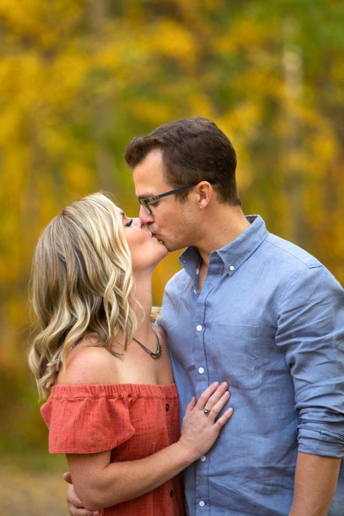 couple kissing in the fall forest