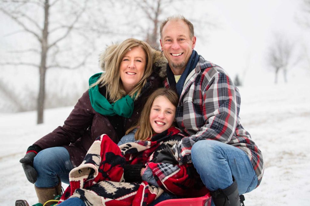 family of three in the snowy park