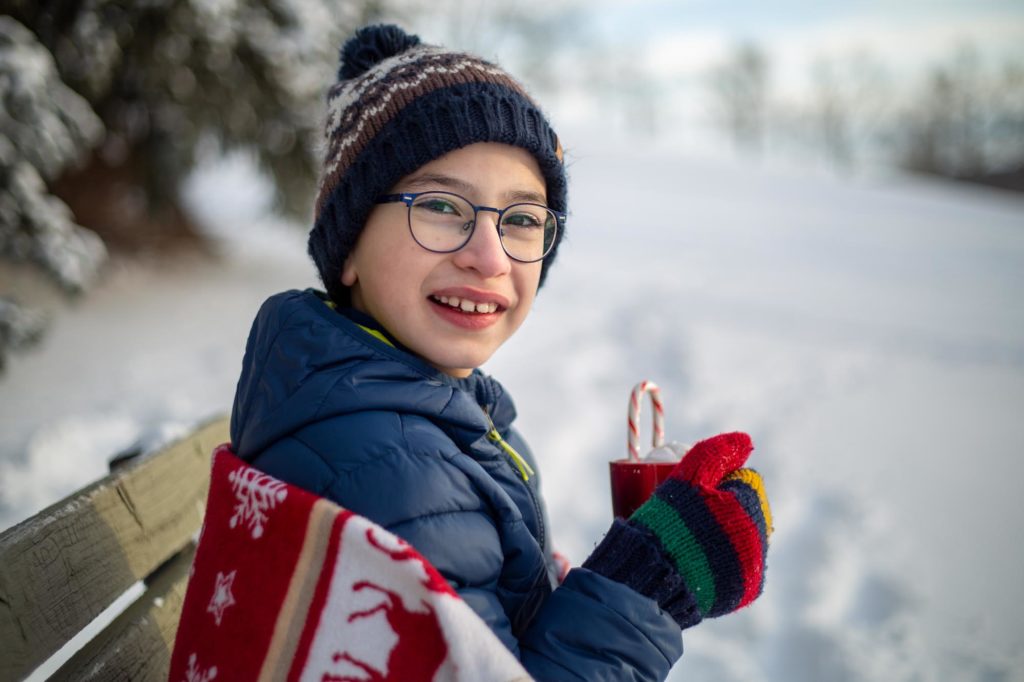 boy drinking hot chocolate in the snow