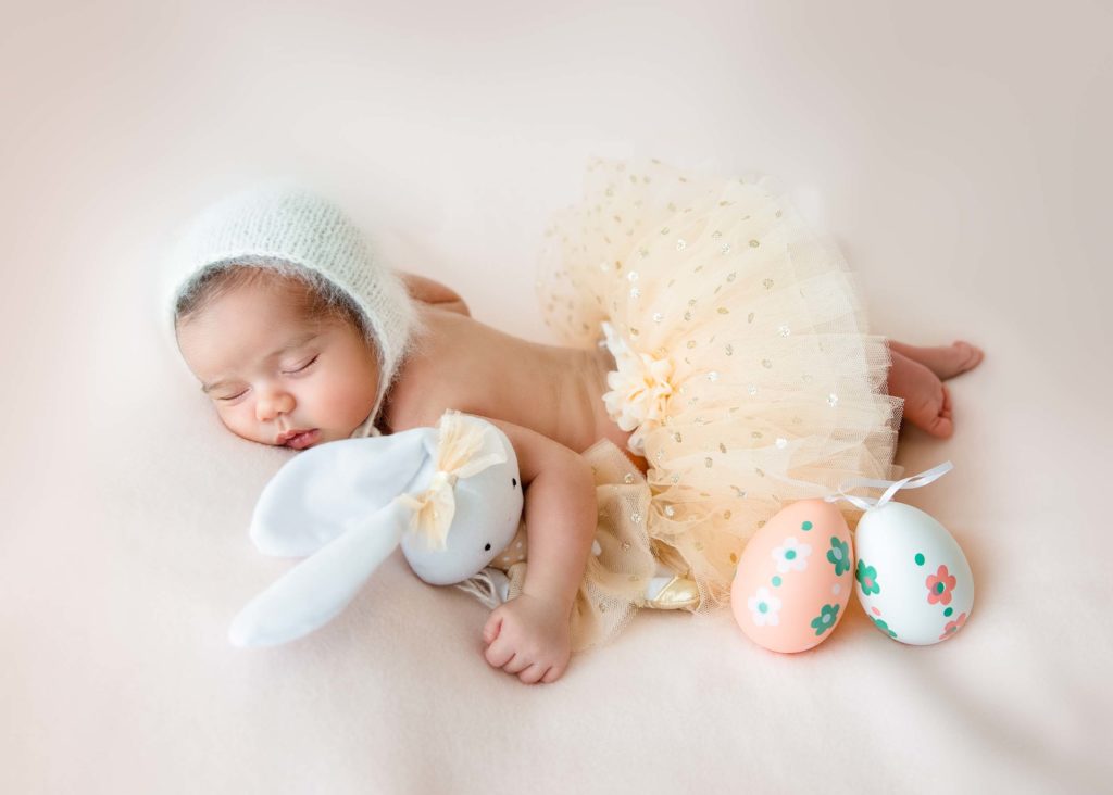 newborn baby girl with an easter bunny