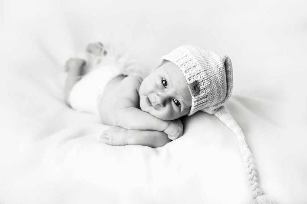 newborn baby looking at camera