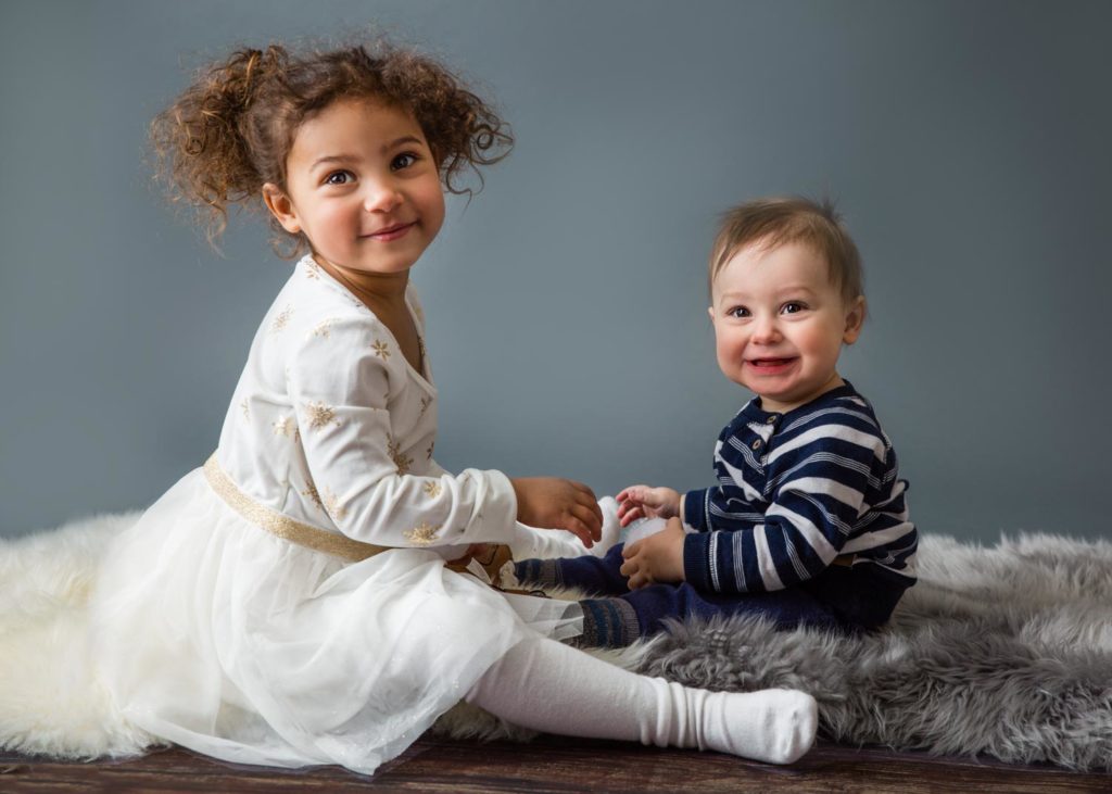 siblings sitting on the floor