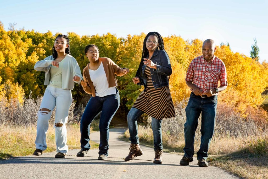 family dancing in the park