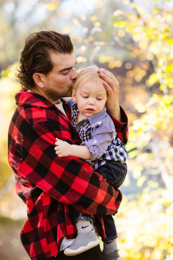 father kissing baby's head