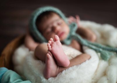 newborn baby in a wooden bowl