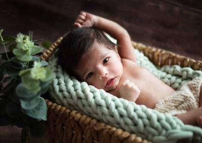 newborn baby in a rattan basket