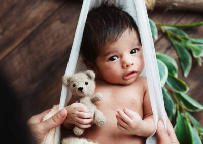 Newborn baby in a tulle sling
