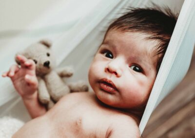 Newborn baby in a tulle sling