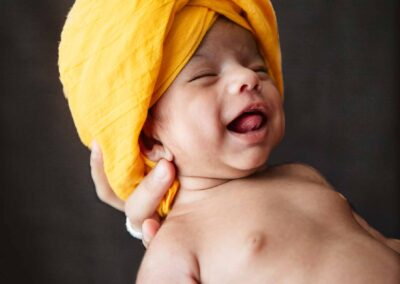 newborn baby in a turban-laughing
