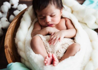 newborn baby in a wooden bowl