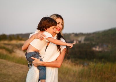 Mother holding son and pointing toward the horizon
