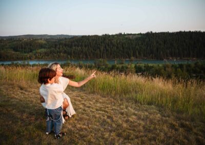 Mother and son looking out over the Bow River and forest