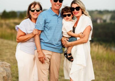 Family of four posing together with sunglasses on
