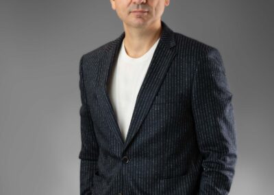 Young man in a dark suit with round neck t-shirt