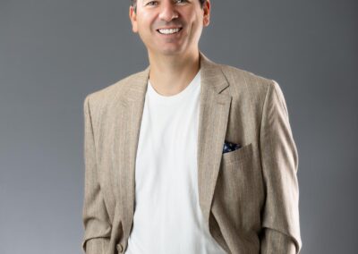 man wearing a light colour suit with his hands in his pockets