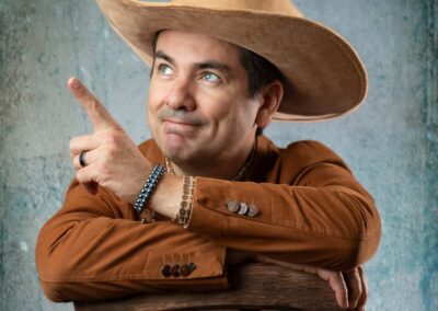 Young man wearing a cowboy hat and sitting in a chair
